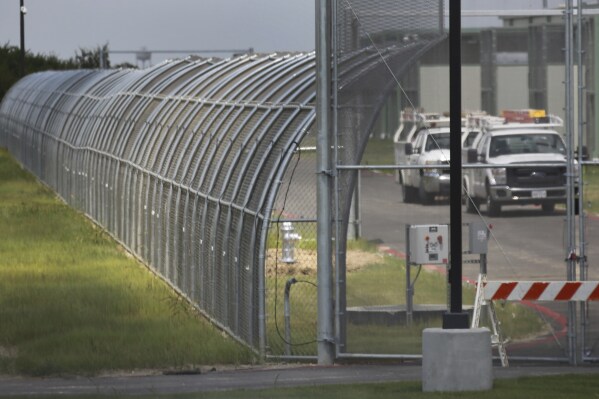 Trucks drive at the Prairieland Detention Center in Alvarado, Texas, Sept. 15, 2016. (Louis DeLuca/The Dallas Morning News via AP, File)
