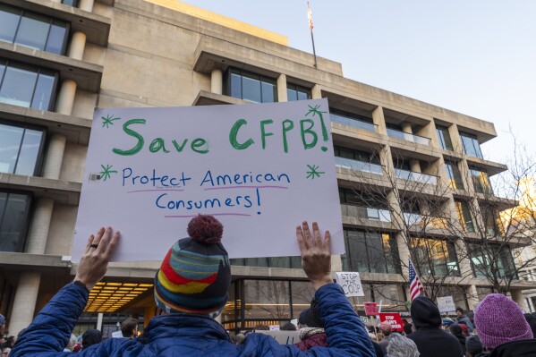 People attend a protest in support of the Consumer Financial Protection Bureau (CFPB), Monday, Feb. 10, 2025, at the CFPB headquarters in Washington. (AP Photo/Jacquelyn Martin)