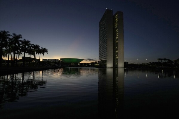 The sun sets at dusk over the headquarters of the National Congress in Brasilia, Brazil, March 31, 2022. (AP Photo/Eraldo Peres, File)