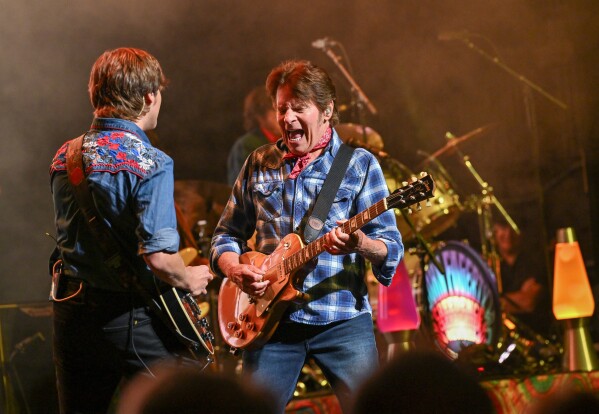 Musician John Fogerty, right, performs with his son Shane Fogerty during his 80th birthday celebration concert at the Beacon Theatre on Thursday, May 29, 2025, in New York. (Photo by Evan Agostini/Invision/AP)