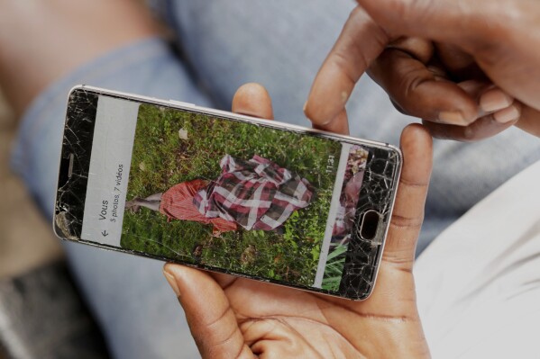 Koutoglo Kossi Mawuli, the uncle of late 15-year-old Jacques Koami Koutoglo, shows a photograph of his body on a mobile phone after it was recovered from a lagoon in Lome, Togo, Tuesday, July 8, 2025. (AP Photo/Erick Kaglan)
