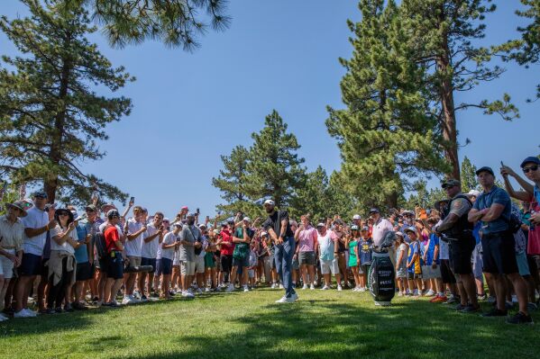 Stephen Curry hits from the spectator area on the 18th hole during the first round of the American Century celebrity golf tournament at Edgewood Tahoe Golf Course in Stateline, Nevada, on Friday, July 11, 2025. (Santiago Mejia/San Francisco Chronicle via AP)