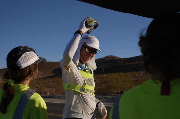 Danny Westergaard cools off with water before starting up after a short break during the Badwater 135 Ultramarathon, Tuesday, July 8, 2025, in Death Valley National Park, Calif. (AP Photo/John Locher)