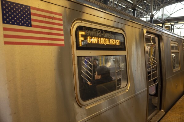 Commuters sit on the F train at the Coney Island-Stillwell Avenue Station, Thursday, Dec. 26, 2024, in New York. (AP Photo/Yuki Iwamura, File)