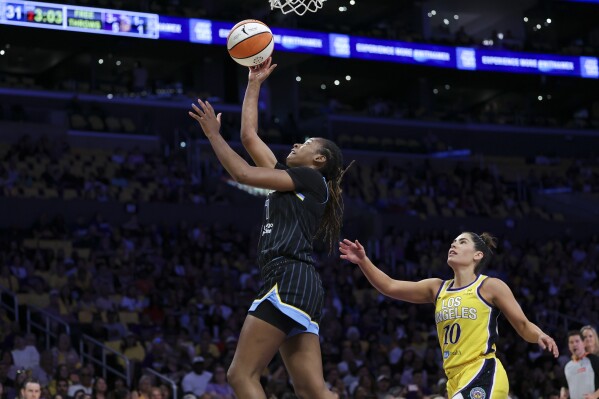 Chicago Sky guard Ariel Atkins, left, drives to the basket as Los Angeles Sparks guard Kelsey Plum (10) watches during the first half of a WNBA basketball game, Sunday, June 28, 2025, in Los Angeles. (AP Photo/Jessie Alcheh)