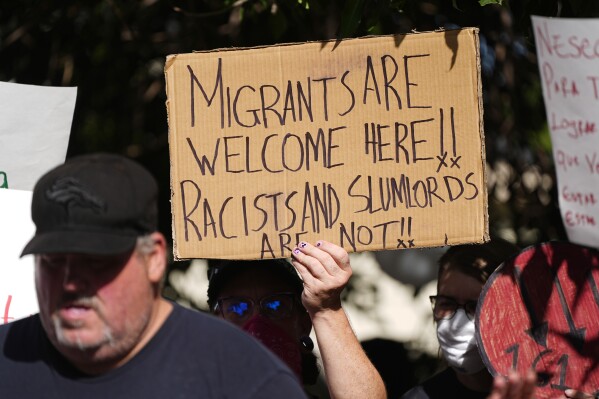 Latin American migrants and their allies demonstrate on Sept. 3, 2024, saying Venezuelans in Aurora, Colo., are being unfairly painted as criminals. (AP Photo/David Zalubowski)