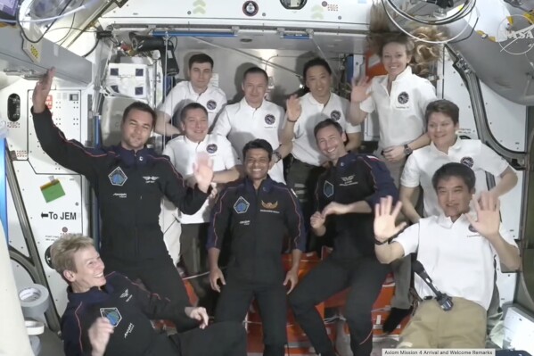 This image provided by NASA shows visiting crew in dark blue, Axiom Space's Peggy Whitson, left, Hungary's Tibor Kapu, 2nd left, India's Shubhanshu Shukla, center, and Poland's Slawosz Uznanski-Wisniewski, center right, aboard the International Space Station, Thursday June 26, 2025. (NASA via AP)