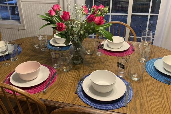 This image provided by Sarah Bellinger shows a table set for a small dinner party with friends on Aug. 25, 2022, in East Hartford, Conn. Bellinger says that throwing her first dinner party was "the most adult thing I did all month." (Sarah Bellinger via AP)wld