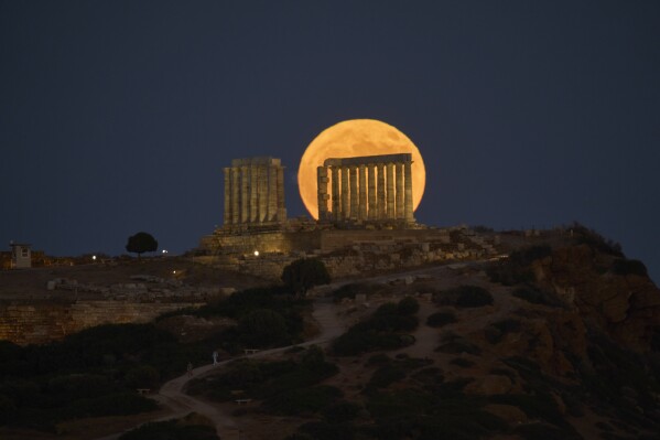 The July full moon, or "Buck Moon," shines brightly over Greece's 2,500-year-old Temple of Poseidon at Cape Sounio, about 70 kilometers (45 miles) south of Athens, Greece, Thursday, July 10, 2025. (AP Photo/Petros Giannakouris)
