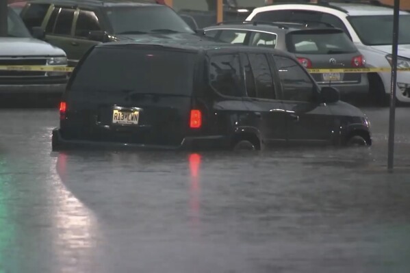 This image made from video shows cars submerged in floodwaters in Rahway, NJ., on July 14, 2025.(WABC-TV via AP)