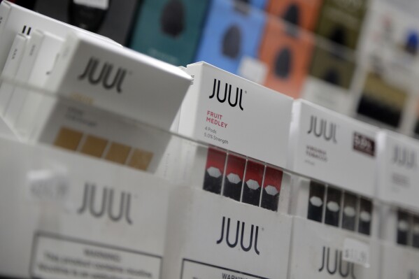 Juul products are displayed at a smoke shop in New York, on Dec. 20, 2018. (AP Photo/Seth Wenig, File)