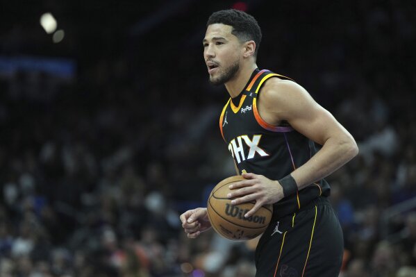 Phoenix Suns guard Devin Booker against the Oklahoma City Thunder during the first half of an NBA basketball game, April 9, 2025, in Phoenix. (AP Photo/Rick Scuteri, File)