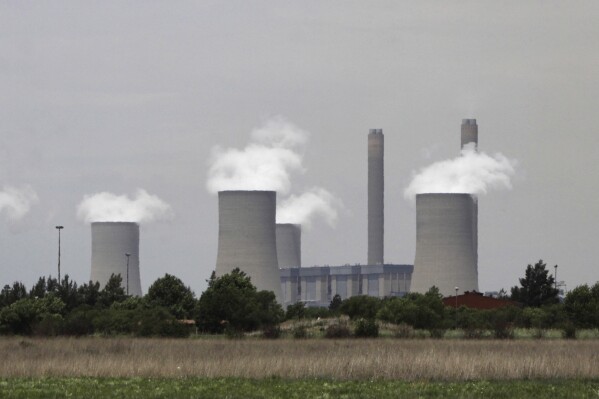 The cooling towers at Eskom's coal-powered Lethabo power station are seen near Sasolburg, South Africa, on Nov. 21, 2011. (AP Photo/Denis Farrell, File)