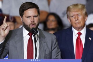Republican Ohio Senate candidate JD Vance speaks as Republican presidential candidate former President Donald Trump listens at a campaign rally in Youngstown, Ohio, Sept. 17, 2022. (AP Photo/Tom E. Puskar, File)