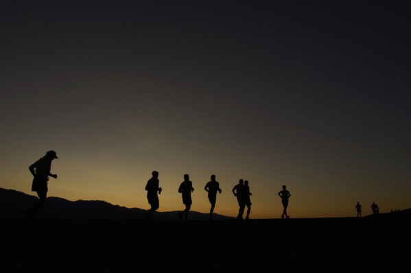Danny Westergaard, leading the center group of runners, competes during the Badwater 135 Ultramarathon, Monday, July 7, 2025, near Badwater Basin in Death Valley National Park, Calif. (AP Photo/John Locher)