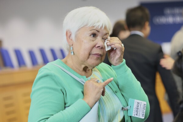 Netherlands' Grace van Zijtveld-Schardijn reacts after the European Court of Human Rights issued its judgment on Russian violations in Ukraine since 2014, including the downing of Malaysia Airlines flight MH17, Wednesday, July 9, 2025 in Strasbourg, eastern France. (AP Photo/Antonin Utz)