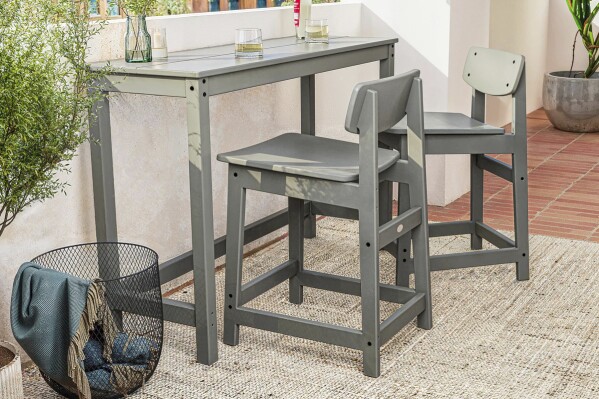 This image provided by Polywood shows their Studio Balcony Set. The slim profile, tuckable chairs and all-weather material makes it a good choice for city balconies or small patios. (Polywood via AP)