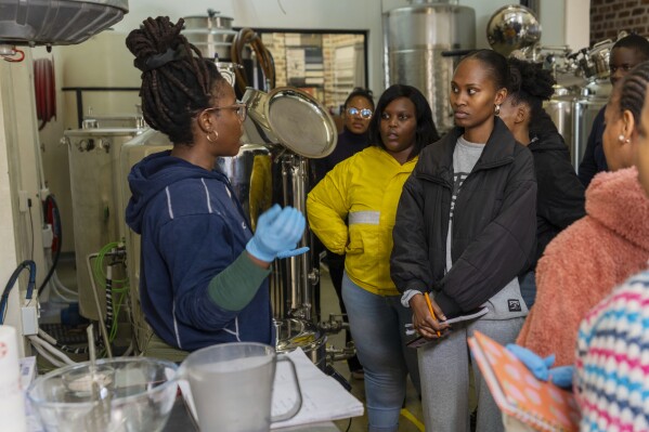 Students prepare to brew beer with South African beer brewing master Apiwe Nxusani-Mawela, in Johannesburg, South Africa, Thursday, June 5, 2025. (AP Photo/Jerome Delay)