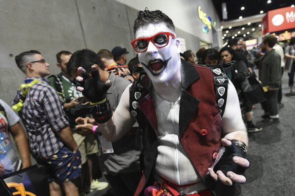 Mike Brown, of New York, dressed as "Harvey Quinn," his own gender-bending spin on the "Harley Quinn" character from the 2016 film "Suicide Squad," strikes a pose during Preview Night at the 2019 C...