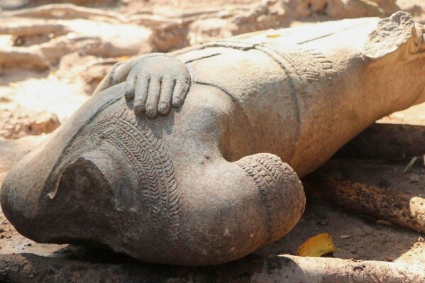 This February 2025 image provided by the Apsara National Authority, shows a headless statue excavated by archaeologists at the Angkor temple complex in Cambodia's Siem Reap province. According to archaeologists, the head of the same statue was dug up in 1927 and is now in Cambodia's National museum in the capital Phnom Penh, and the two parts may be reattached for display. (Apsara National Authority via AP)
