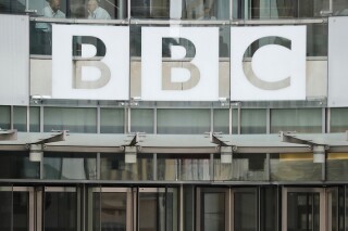 This photo shows a BBC sign outside the entrance to the headquarters of the publicly funded media organization in London, July 19, 2017. (AP Photo/Frank Augstein, File)