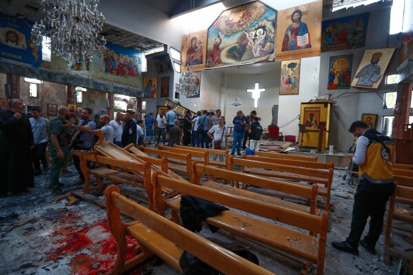 Syrians gather inside Mar Elias church where a suicide bomber detonated himself in Dweil'a in the outskirts of Damascus, Syria, Sunday June 22, 2025. (AP Photo/Omar Sanadiki)
