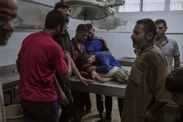 Palestinians mourn a child killed in an Israeli military airstrike on Gaza, at the morgue of Shifa Hospital in Gaza City, Saturday, July 12, 2025. (AP Photo/Jehad Alshrafi)