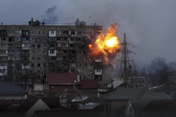 An apartment building explodes after a Russian army tank fires in Mariupol, Ukraine, Friday, March 11, 2022. (AP Photo/Evgeniy Maloletka)
