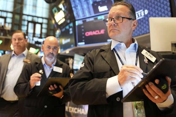 Ed Curran works on the floor at the New York Stock Exchange in New York, Wednesday, July 16, 2025. (AP Photo/Seth Wenig)