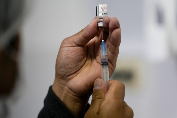 A healthcare worker prepares a shot of the Pfizer COVID-19 vaccine in La Paz, Bolivia, Jan. 7, 2025. (AP Photo/Juan Karita, File)