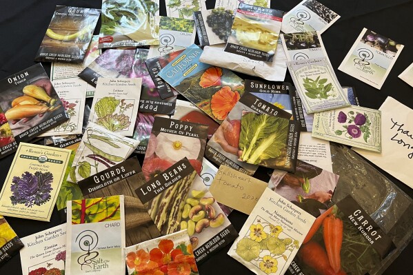This March 17, 2022, image provided by Jessica Damiano shows a collection of old seed packages spread out on a table on Long Island, N.Y. Seeds may sprout past their expiration dates, so it's a good idea to test them for viability before disposing of (or planting) them. (Jessica Damiano via AP)