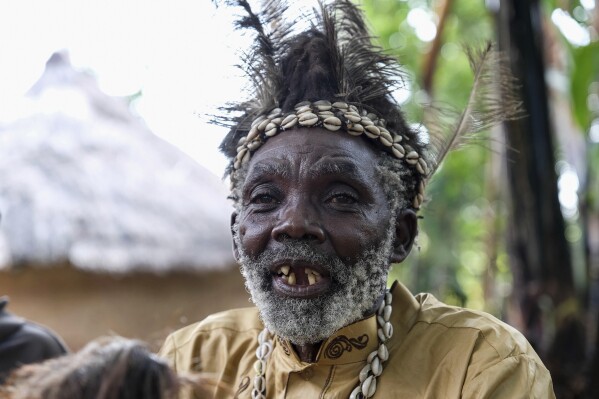 CORRECTS CITY - Seer Atukung Tafala speaks during an interview with The Associated Press outside his igloo-like shrine in Mbale, Uganda, Saturday, June 21, 2025. (AP Photo/Hajarah Nalwadda)