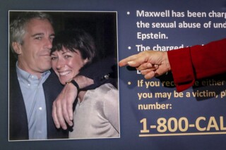 FILE - Audrey Strauss, acting U.S. attorney for the Southern District of New York, points to a photo of Jeffrey Epstein and Ghislaine Maxwell, during a news conference in New York, July 2, 2020. (AP Photo/John Minchillo, File)