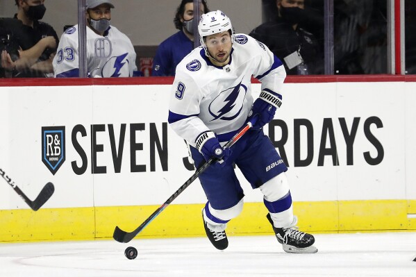 Tampa Bay Lightning's Tyler Johnson moves the puck against the Carolina Hurricanes during the second period of an NHL hockey game in Raleigh, N.C., Thursday, Jan. 28, 2021. (AP Photo/Karl B DeBlaker, File)