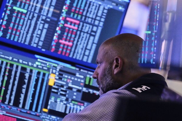 Specialist Meric Greenbaum works at his post on the floor of the New York Stock Exchange, Tuesday, July 8, 2025. (AP Photo/Richard Drew)