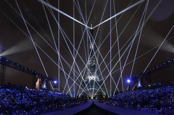 A light show is projected from the Eiffel Tower in Paris, France, during the opening ceremony of the 2024 Summer Olympics, Friday, July 26, 2024. (AP Photo/David J. Phillip)