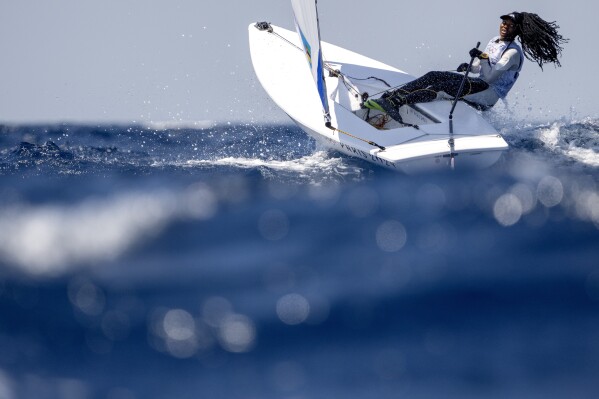 Mozambique's Deizy Nhaquile battles rough seas during a women's dinghy race, Saturday, Aug. 3, 2024, during the 2024 Summer Olympics in Marseille, France. (AP Photo/Jacquelyn Martin)