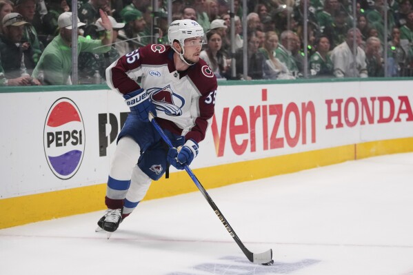 Colorado Avalanche defenseman Ryan Lindgren (55) controls the puck in the first period in Game 7 of a first-round NHL hockey playoff series against the Dallas Stars, May 3, 2025, in Dallas. (AP Photo/Julio Cortez, File)