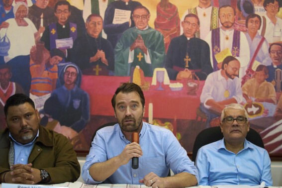 Noah Bullock, director of the human rights organization Cristosal, center, gives a press conference in Guatemala City, Thursday, July 17, 2025, to announce that Cristosal is suspending their activities in El Salvador. (AP Photo/Moises Castillo)
