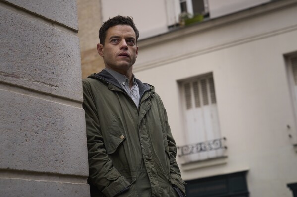 This image released by 20th Century Studios shows Rami Malek in a scene from "The Amateur." (John Wilson/20th Century Studios via AP)