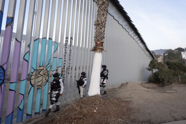 Members of the Mexican National Guard patrol along the border wall separating Mexico and the United States, in Tijuana, Jan. 20, 2025. (AP Photo/Gregory Bull, File)