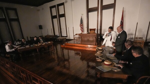Larry Jones, who portrays William Jennings Bryan, in white suit, rehearses with other actors in the play "Destiny in Dayton", July 8, 2025, in Dayton, Tenn. (AP Photo/Mike Stewart)