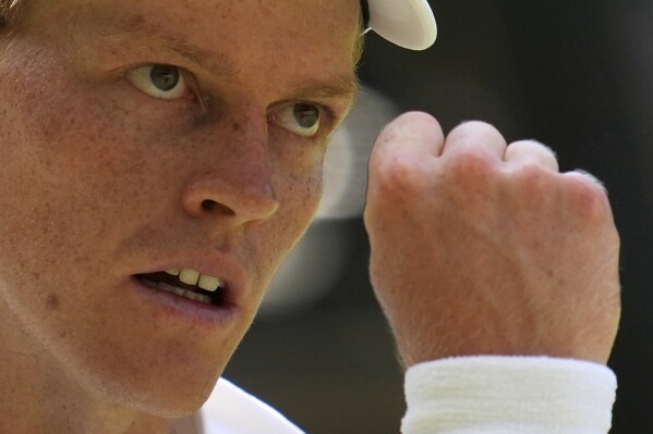 Italy's Jannik Sinner reacts after winning a point against Carlos Alcaraz of Spain in the men's singles final at the Wimbledon Tennis Championships in London, Sunday, July 13, 2025. (AP Photo/Kin Cheung)