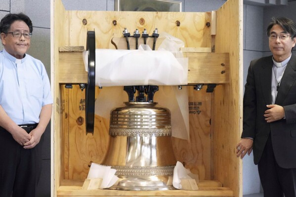 The bell, which was reproduced and returned by a group of Americans, is shown to the media at the Urakami Cathedral, nearly 80 years after the cathedral was destroyed by the U.S. atomic bombing near the end of World War, in Nagasaki, western Japan, on May 15, 2025. (Kyodo News via AP)