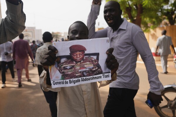 Nigeriens participate in a march called by supporters of coup leader Gen. Abdourahmane Tchiani, pictured, in Niamey, Niger, July 30, 2023. (AP Photo/Sam Mednick, File)