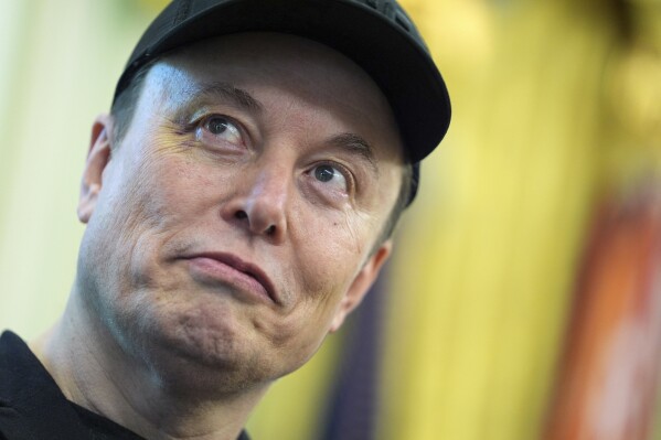 Elon Musk listens as President Donald Trump speaks during a news conference in the Oval Office of the White House, Friday, May 30, 2025, in Washington. (AP Photo/Evan Vucci)