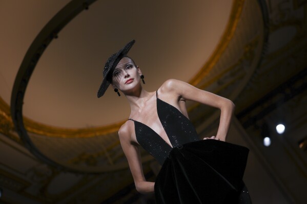 A model wears a creation as part of the Giorgio Armani Prive Fall-Winter 2025/26 Haute Couture collection presented Tuesday, July 8, 2025, in Paris. (AP Photo/Tom Nicholson)