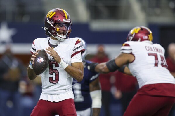 Washington Commanders quarterback Jayden Daniels looks to pass against the Dallas Cowboys during the first half of an NFL football game, Sunday, Jan. 5, 2025, in Arlington, Texas. (AP Photo/Gareth Patterson)