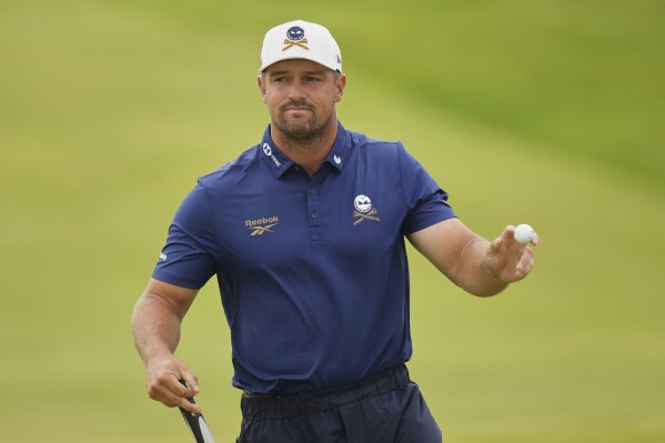 Bryson DeChambeau of the United States acknowledges the crowd on the 3rd green during the first round of the British Open golf championship at the Royal Portrush Golf Club, Northern Ireland, Thursday, July 17, 2025. (AP Photo/Francisco Seco)