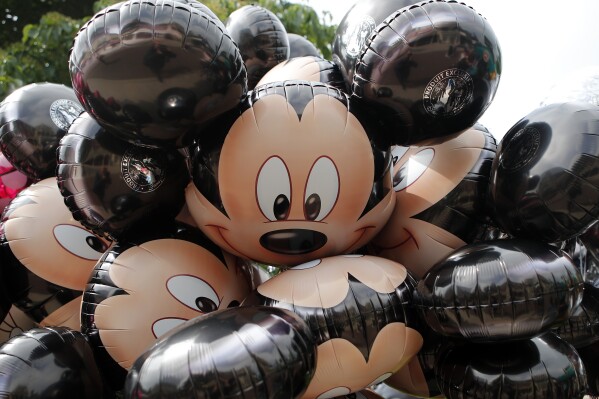 Mickey Mouse balloons are displayed at Disneyland Paris in Chessy, France, June 8, 2018. (AP Photo/Francois Mori, File)